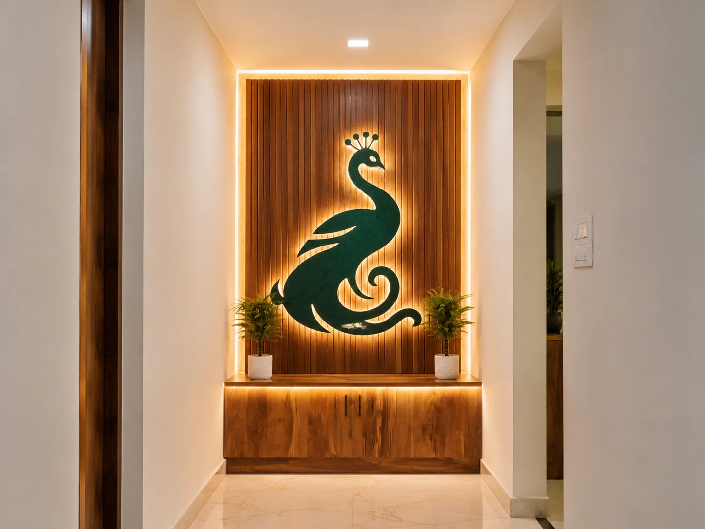 Illuminated peacock wall feature at Sri Valli Residency